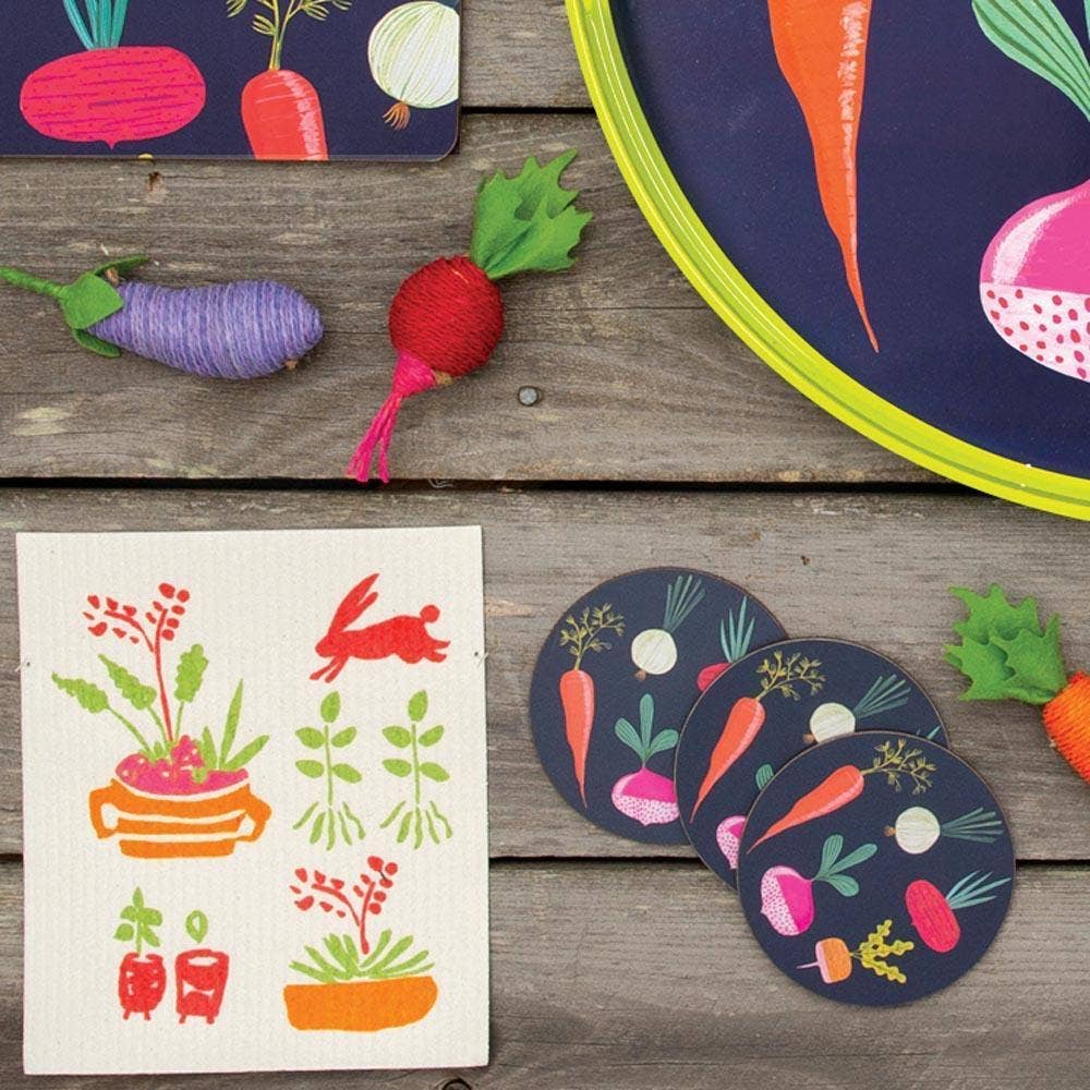 Colorful vegetable-themed coasters and cards on a wooden surface
