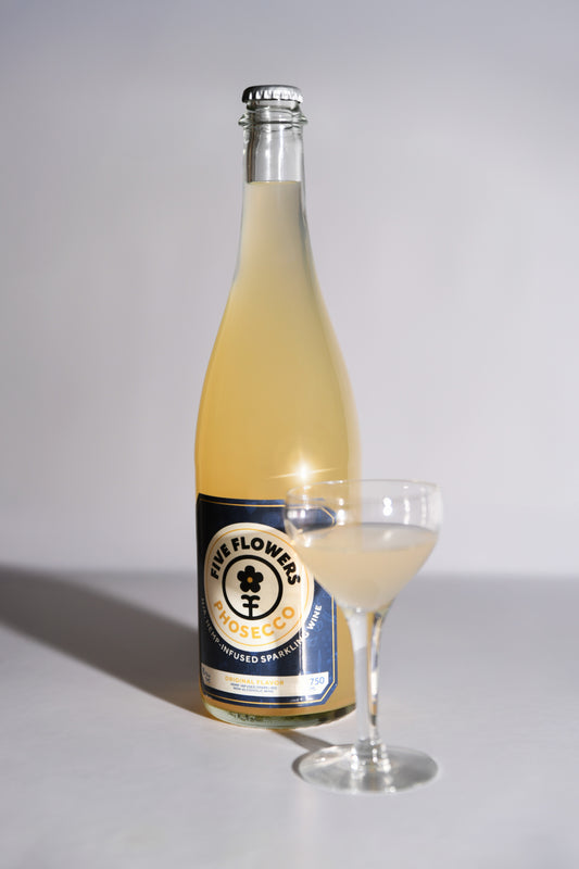 Bottle and glass of a beverage with a label on a white background