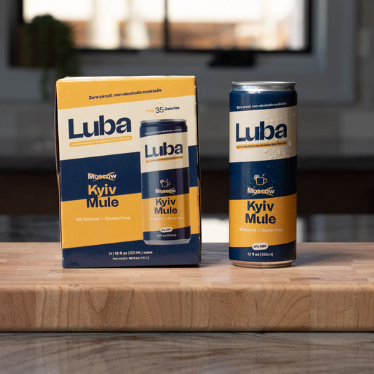 Luba Kyiv Mule can and box on a wooden surface with a blurred background