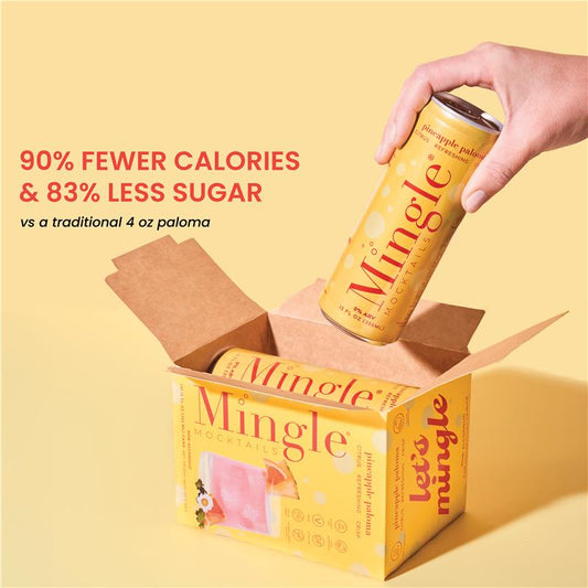A person holding a can of Mingle Sparkling Pineapple Paloma, with the product's packaging visible in the background.
