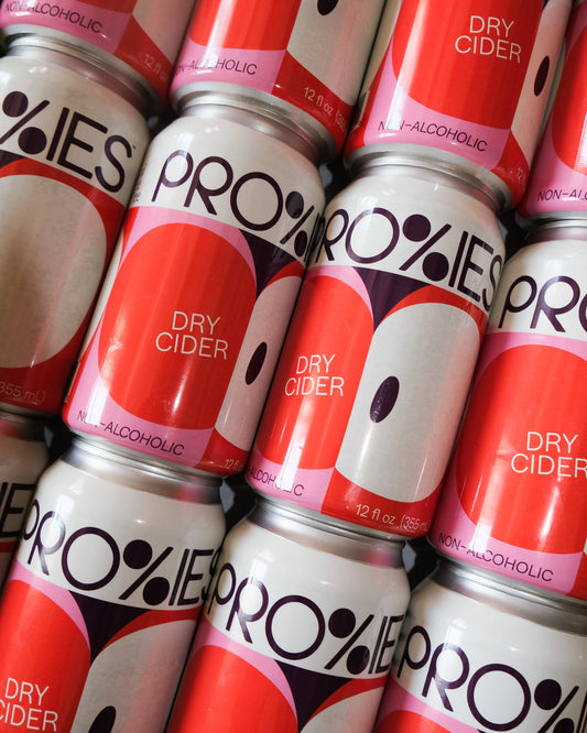 Multiple cans of Pro Royies dry cider stacked together.