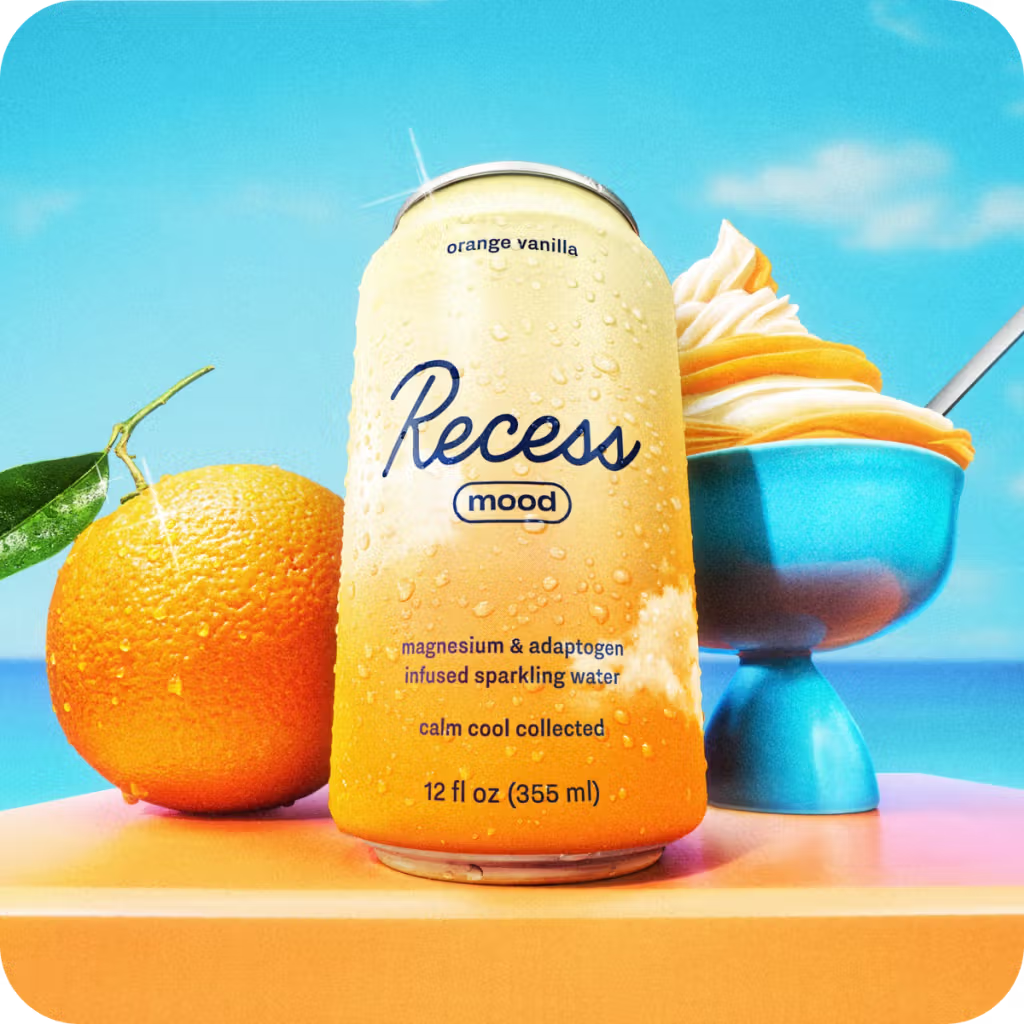 Can of Recess orange vanilla sparkling water with an orange and dessert in the background