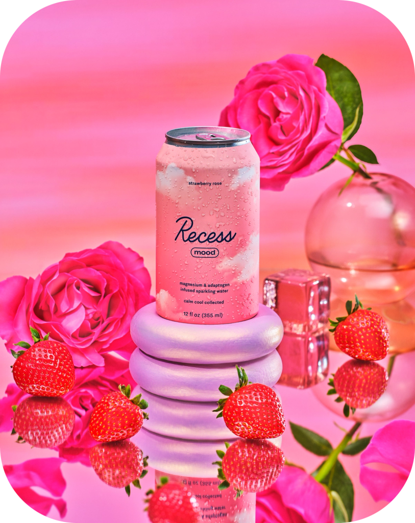 Pink can of 'Recess' with strawberries and roses on a pink background