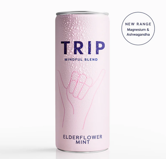 A can of TRIP Mindful Blend Elderflower Mint Sparkling Botanical Drink with a pink background and white decorative elements. The can is labeled with the brand and product name, and has a symbol suggesting relaxation.