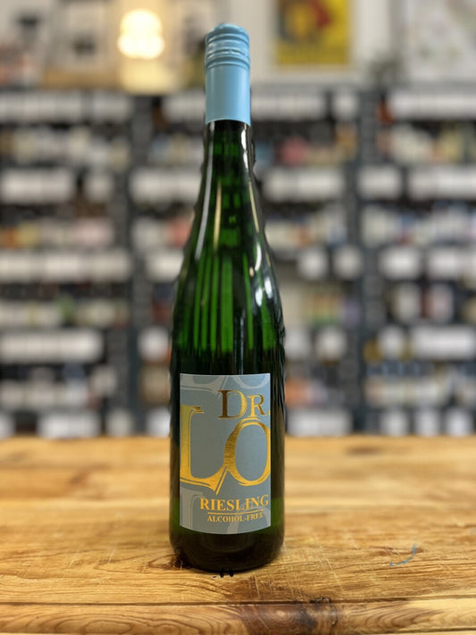 Bottle of Dr Lo Riesling on a wooden surface with a blurred store shelf in the background