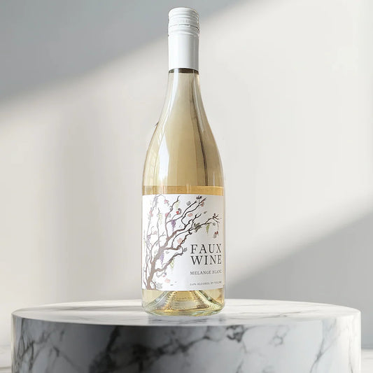 Bottle of 'FAUX WINE' on a marble surface with a neutral background