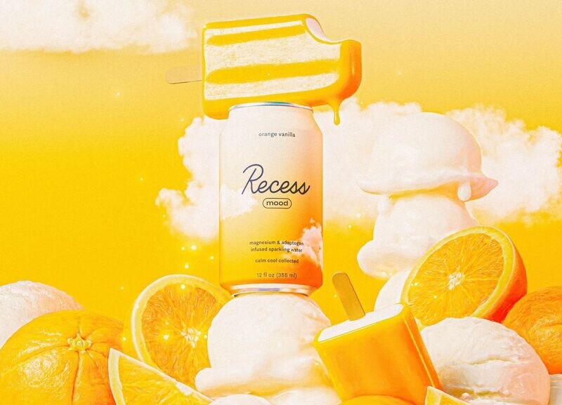 A can of Recess mood orange vanilla cold coffee is surrounded by orange slices, ice cream scoops, and an orange popsicle against a bright yellow background with white clouds.