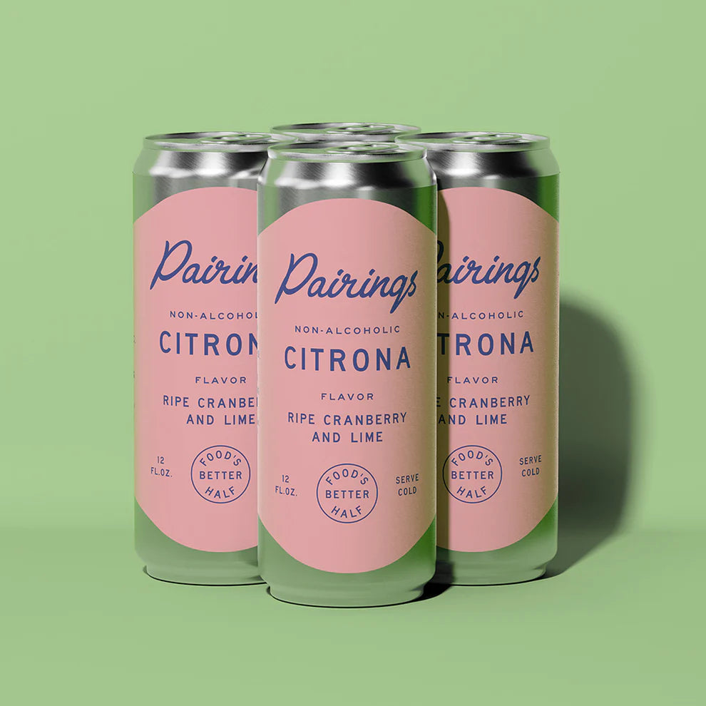 Three cans of Pairings Citrona non-alcoholic drink on a green background
