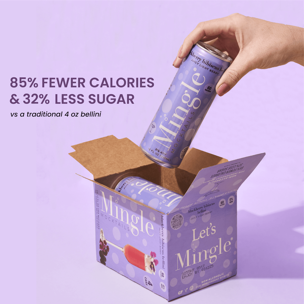 A person holding a can of Mingle Blackberry Hibiscus Bellini, with the product's box visible in the background.
