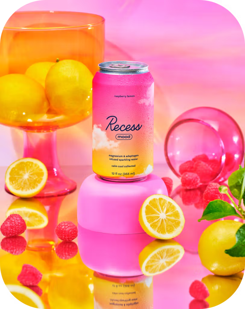 Recess raspberry lemonade can with lemons, raspberries, and a pink background