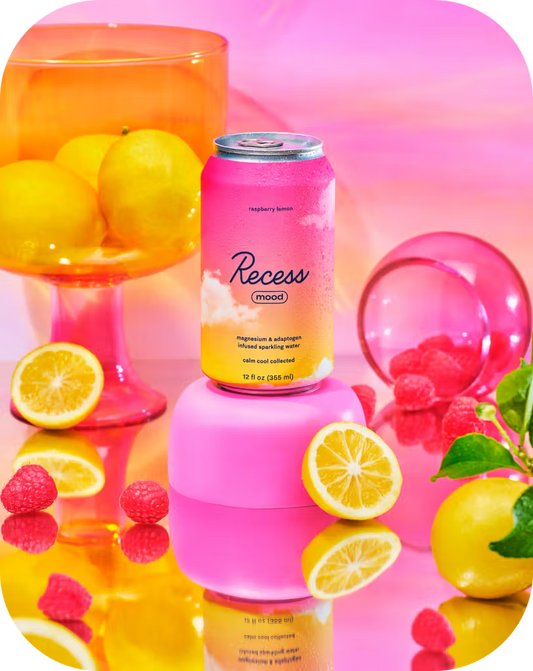 Recess raspberry lemonade can with lemons, raspberries, and a pink background