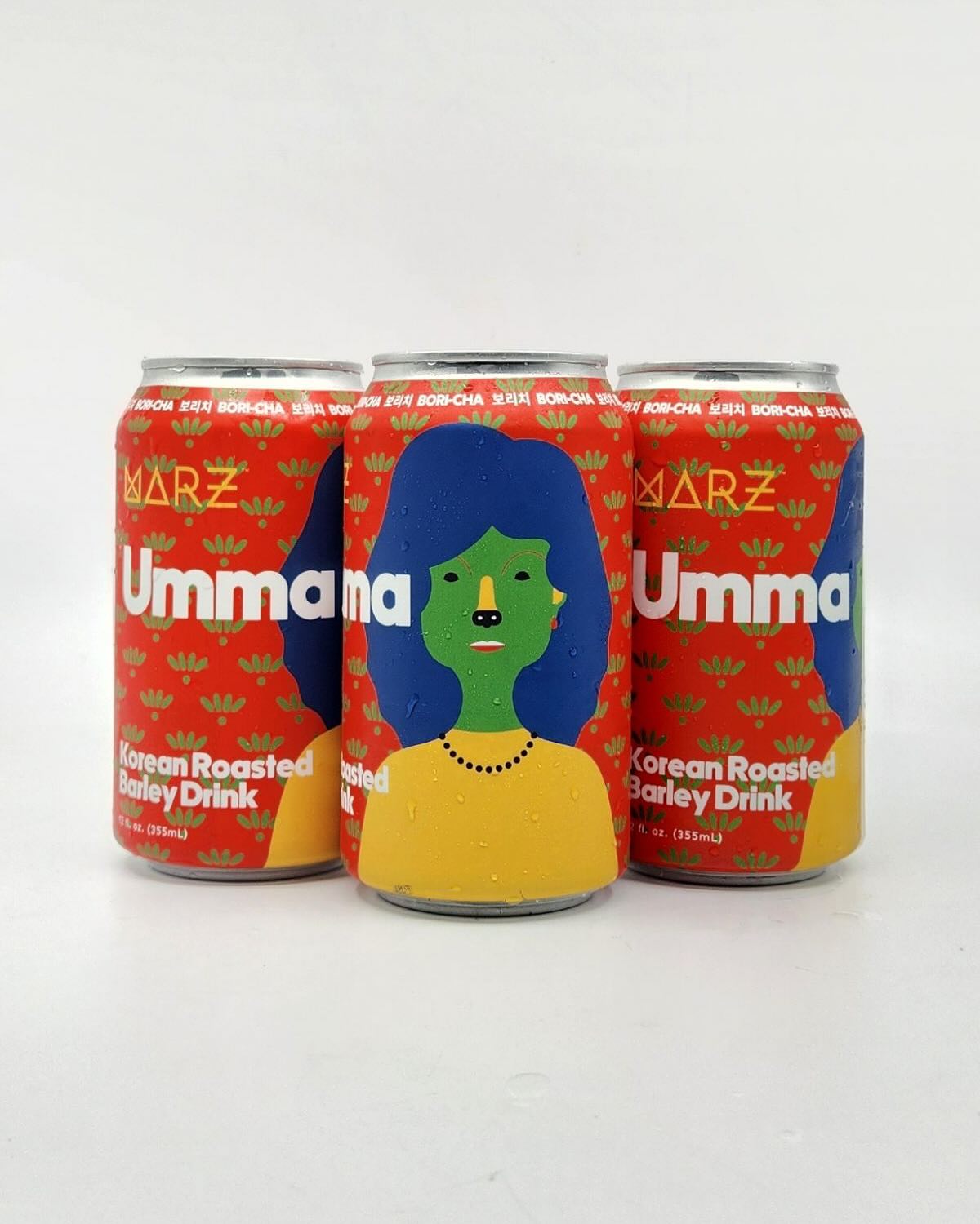 Three cans of Umma Korean Roasted Barley Drink with colorful design on a white background